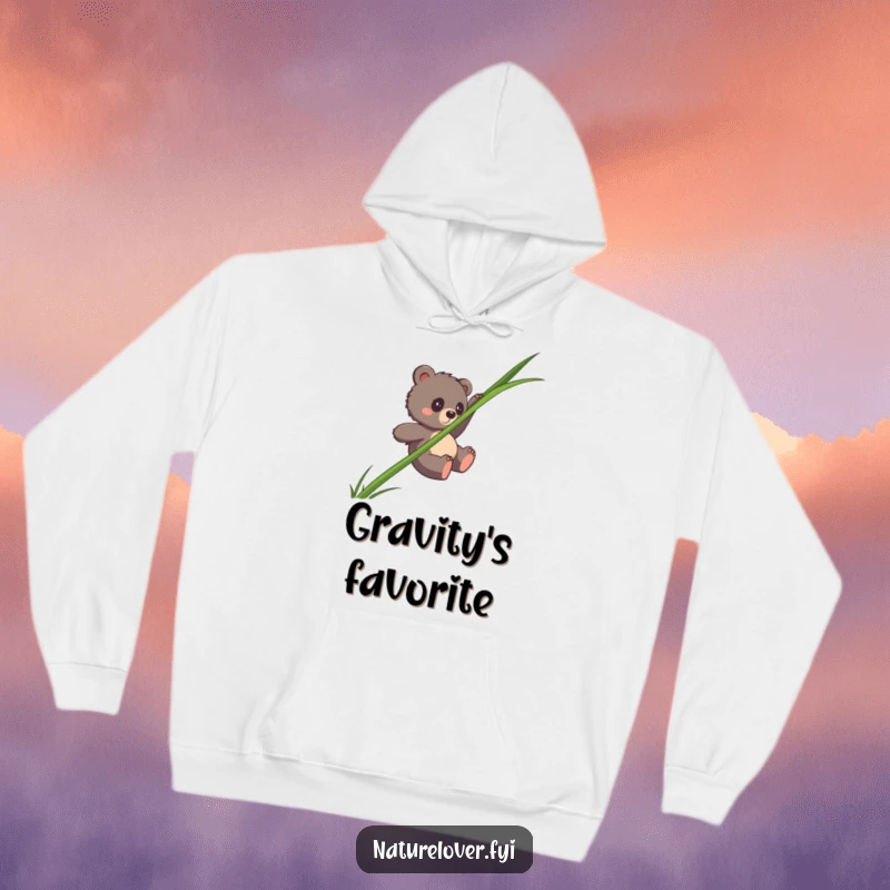 Funny bear cub hoodie showing a clumsy cub sliding down an enormous single blade of grass, cozy and amusing apparel.