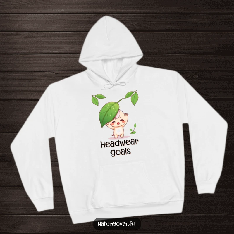Funny Hoodie showing a playful character balancing a big leaf on its head, embodying carefree fun.